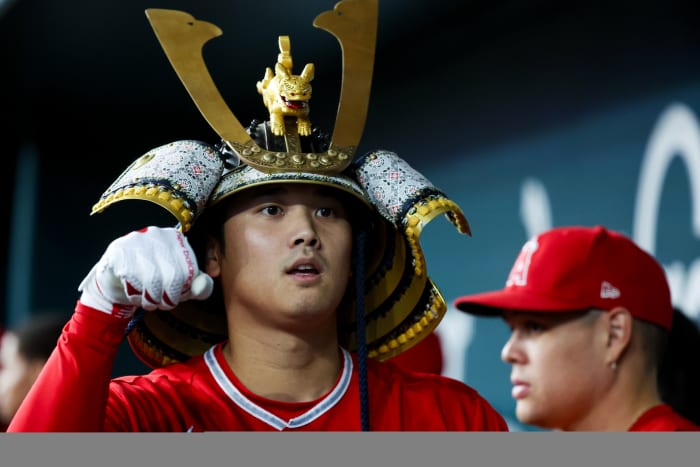 Los Angeles Angels designated hitter Shohei Ohtani celebrates with teammates while wearing a samurai helmet after hitting a home run in the first inning against the Texas Rangers at Globe Life Field Wednesday night.